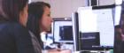 A woman looking at a computer screen as she works