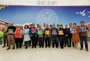 A group photo of many different people holding signs showing the 17 UN Sustainable Development Goals