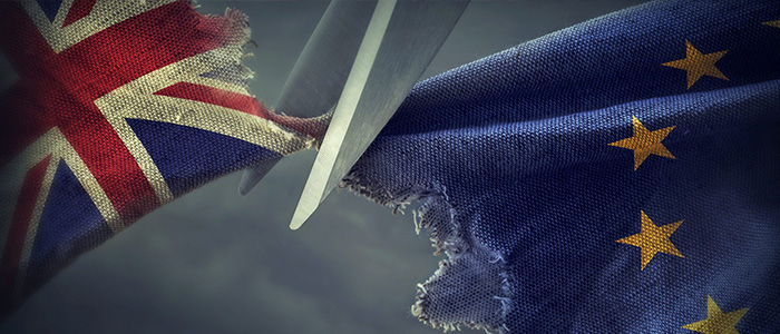 A pair of scissors separating two pieces of fabric which are tearing apart - one is the British union flag, the other is the European Union flag.Image credit: egal | iStockphoto  https://www.istockphoto.com/photo/brexit-concept-gm542714930-97216807