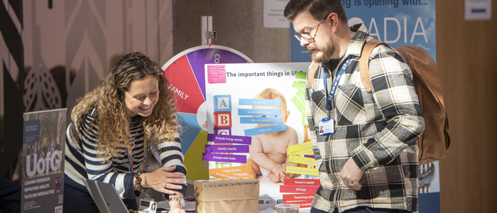 Photo of a staff member and attendee at a community engagement event