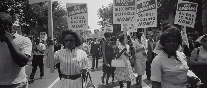 Photo by Library of Congress on Unsplash: Civil rights march on Washington, D.C. Film negative by photographer Warren K. Leffler, 1963. From the U.S. News & World Report Collection. Library of Congress Prints & Photographs Division. Photograph shows a procession of African Americans carrying signs for equal rights, integrated schools, decent housing, and an end to bias.