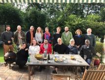 Image of Pat Monaghan's research team standing at a table outdoors