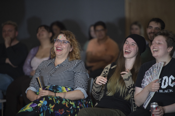 Audience laughing during comedy event at ARC