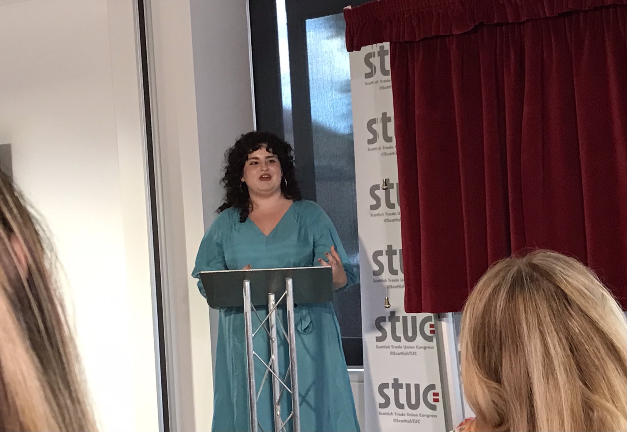 A woman giving a speech at the STUC