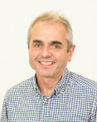 A head and shoulders profile shot of Professor Tom Evans against a white background