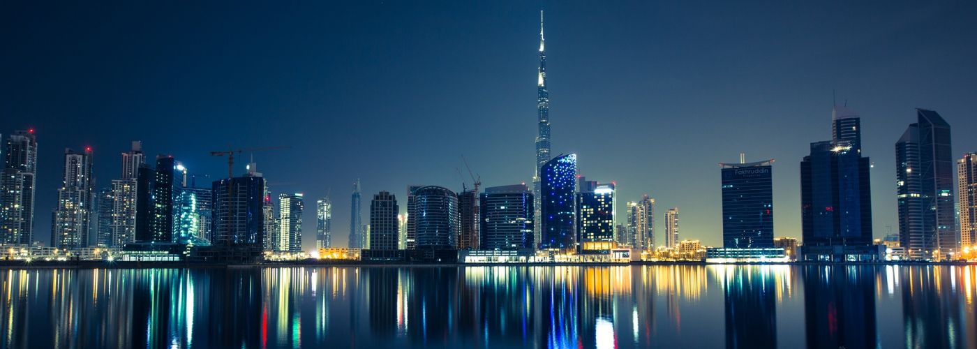 Night skyline of skyscrapers by water