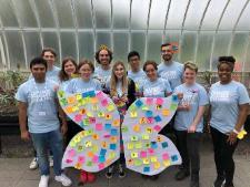 Photograph showing the entire GSF in Action Botanics team with a large butterfly covered in post it notes. 