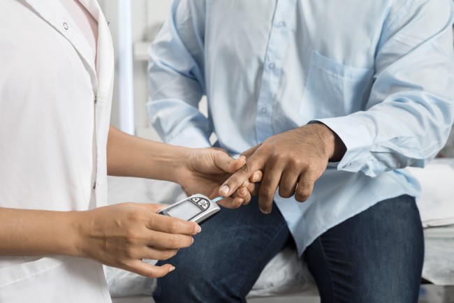 South Asian male having a blood sugar test