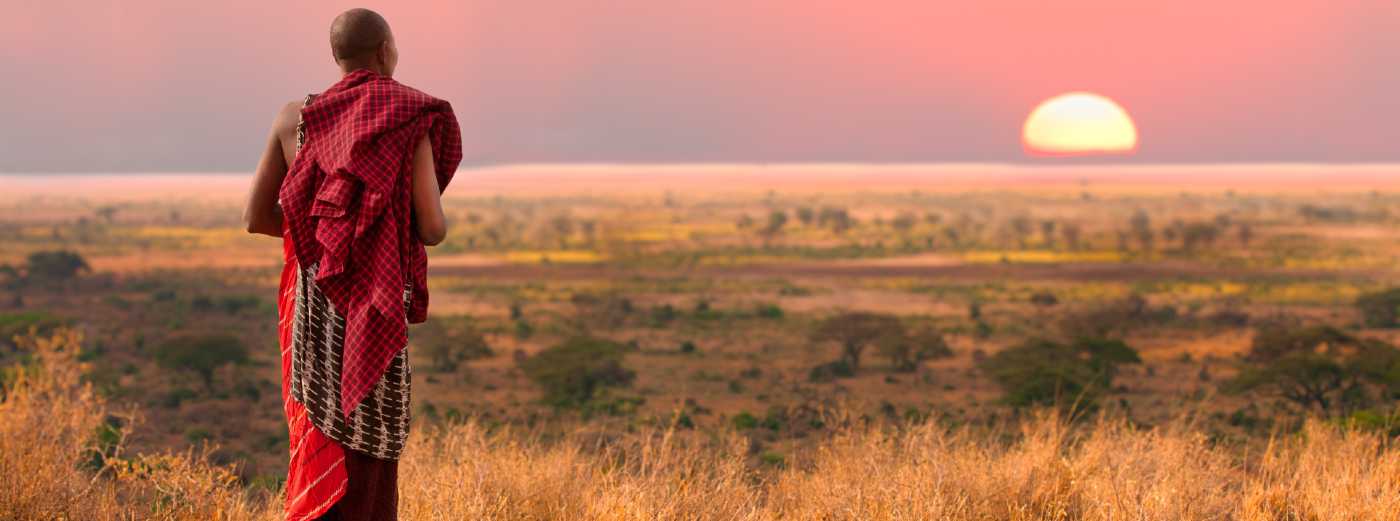 Masai tribesman walking on plain in Africa