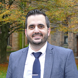 Mr Evangelos Seretis standing in the west quadrangle, University of Glasgow