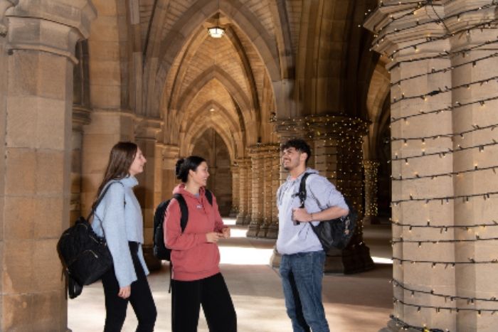 University of Glasgow students standing in the cloisters