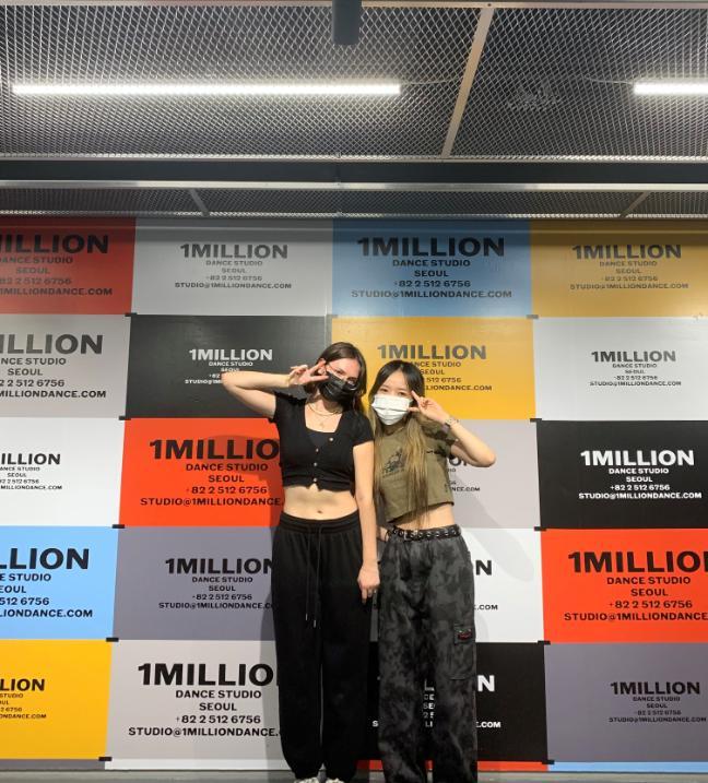 Two young people outside 1 Million Dance Studio in Korea