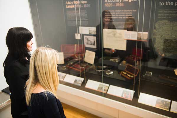 Two women looking at medial objects