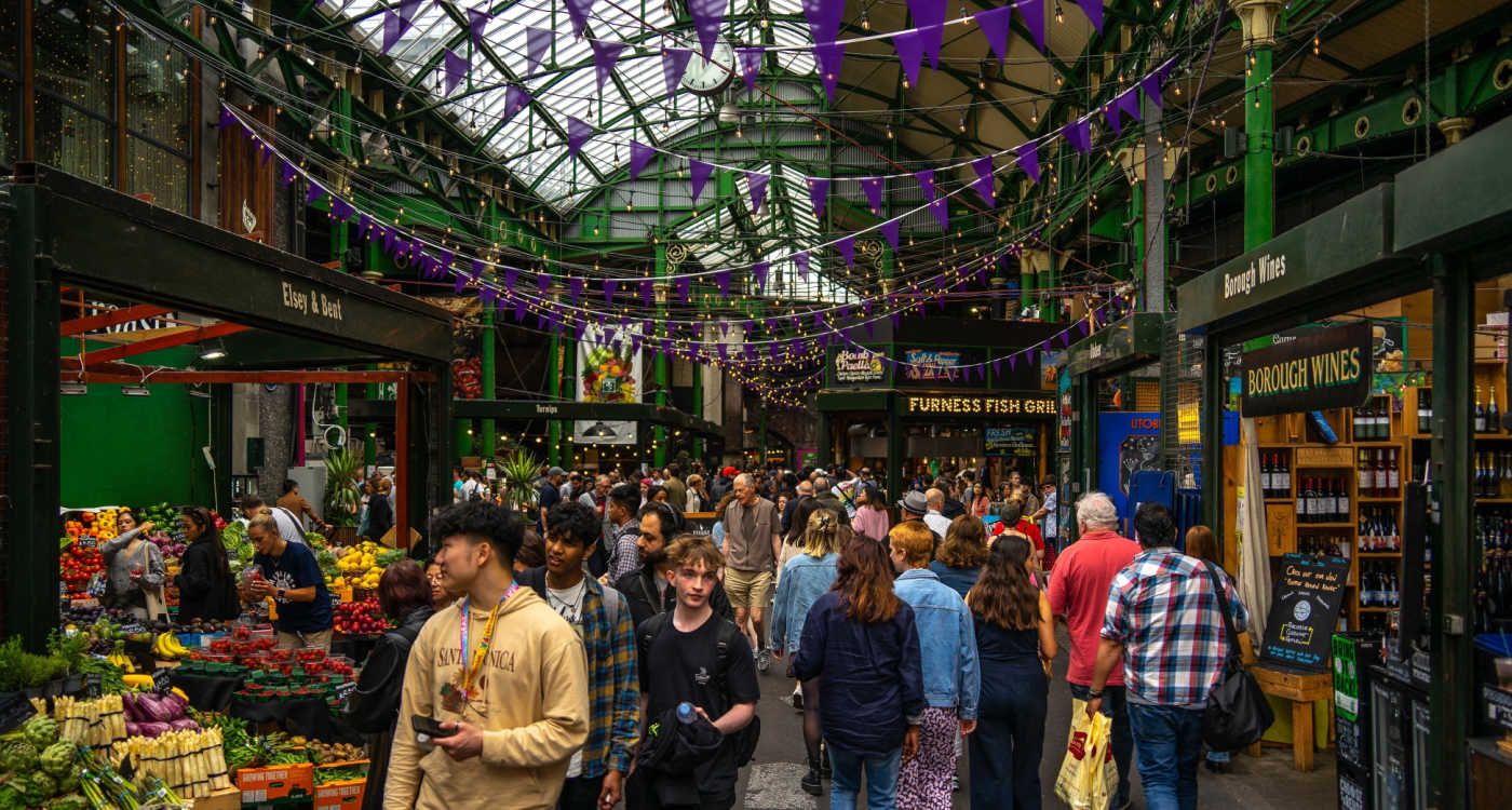 Busy interior of Borough Market with people browsing around the stalls [photo: Shutterstock]