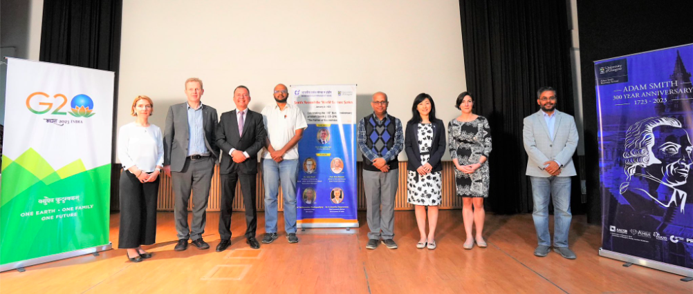 Speakers at the Indian Institute of Management Indore together with promotional banners inckuding one saying 'Adam Smith 300 Anniversary'