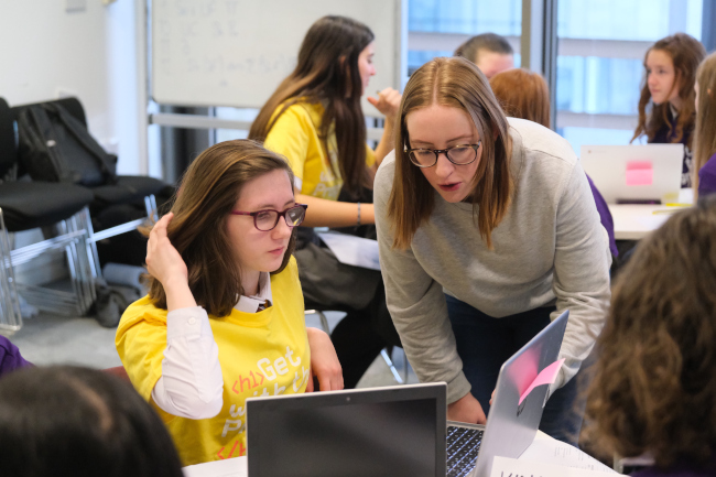 Toni Scullion of dressCode and STACS helps an attendee at the hackathon event