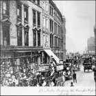 Photograph of the view looking west along Kensington High Street featuring a row of John Barker & Company Ltd shops on the left, c1908.  (GUAS Ref: HF 51/8/1/1/3 photo 8. Copyright reserved.)