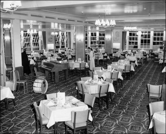 Photograph featuring a waitress preparing tables in the restaurant, c1957. (GUAS Ref: HF 51/6/1/6/1. Copyright reserved.)