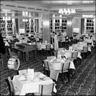 Photograph featuring a waitress preparing tables in the restaurant, c1957.  (GUAS Ref: HF 51/6/1/6/1. Copyright reserved.)
