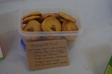 photo of a tub of light almond biscuits baked by a wintering well participant to share with others