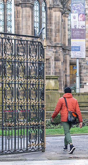 A student walking through Memorial Gate