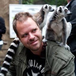 Image of Oskar Brattstrom with two Lemur's on his back