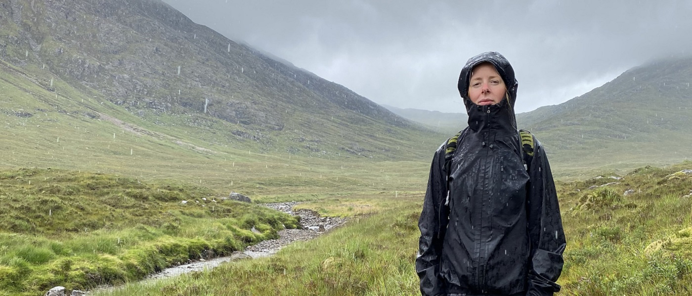 Photo of Georgia McDowall standing in countryside on a very rainy day