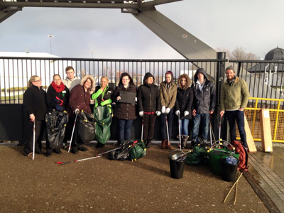Photograph showing a group of ASDA and McDonalds employees holding litter pickers and bin bags.