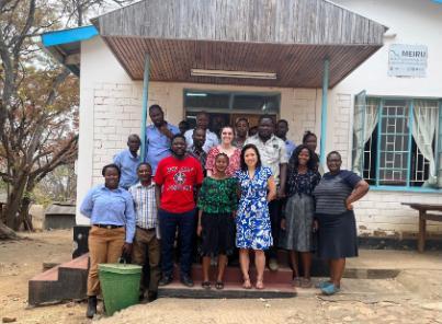 Big group of people from the MEIRU project stood outside a building in Malawi. 