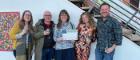 Image of 4 UofG researchers holding a certificate with Walt Adams to the right