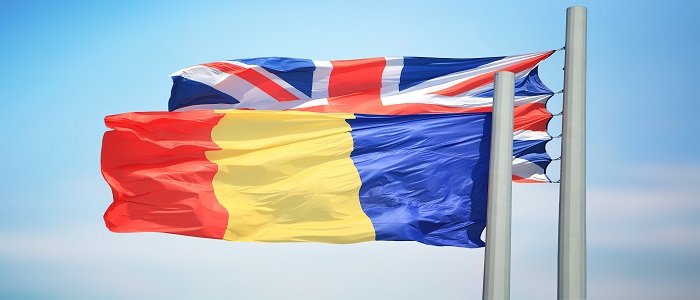 Romanian and UK flags in the sunshine