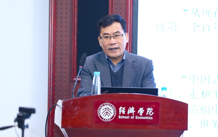 A man at a podium with Chinese characters and words 'School of Economics' on it. Source: Peking University