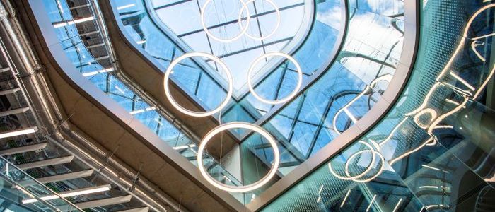 Hoop lights installation hanging from the ceiling through the centre of the ARC building