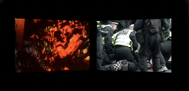 two film screens against black - one showing red, unidentifiable image, one showing police in bright yellow high-vis vests holding a protester on the ground 