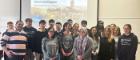 A group of students standing for a photo in a room at Prague University