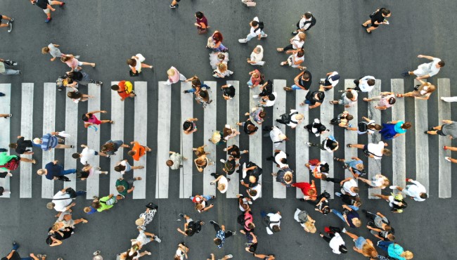 An aerial picture of many people on a zebra crossing