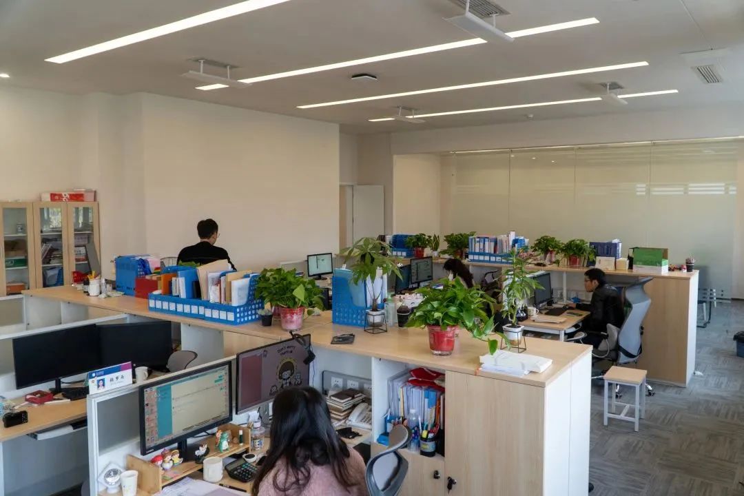 Staff working in cubicles in the newly refurbished Student Affairs Centre at Chengdu