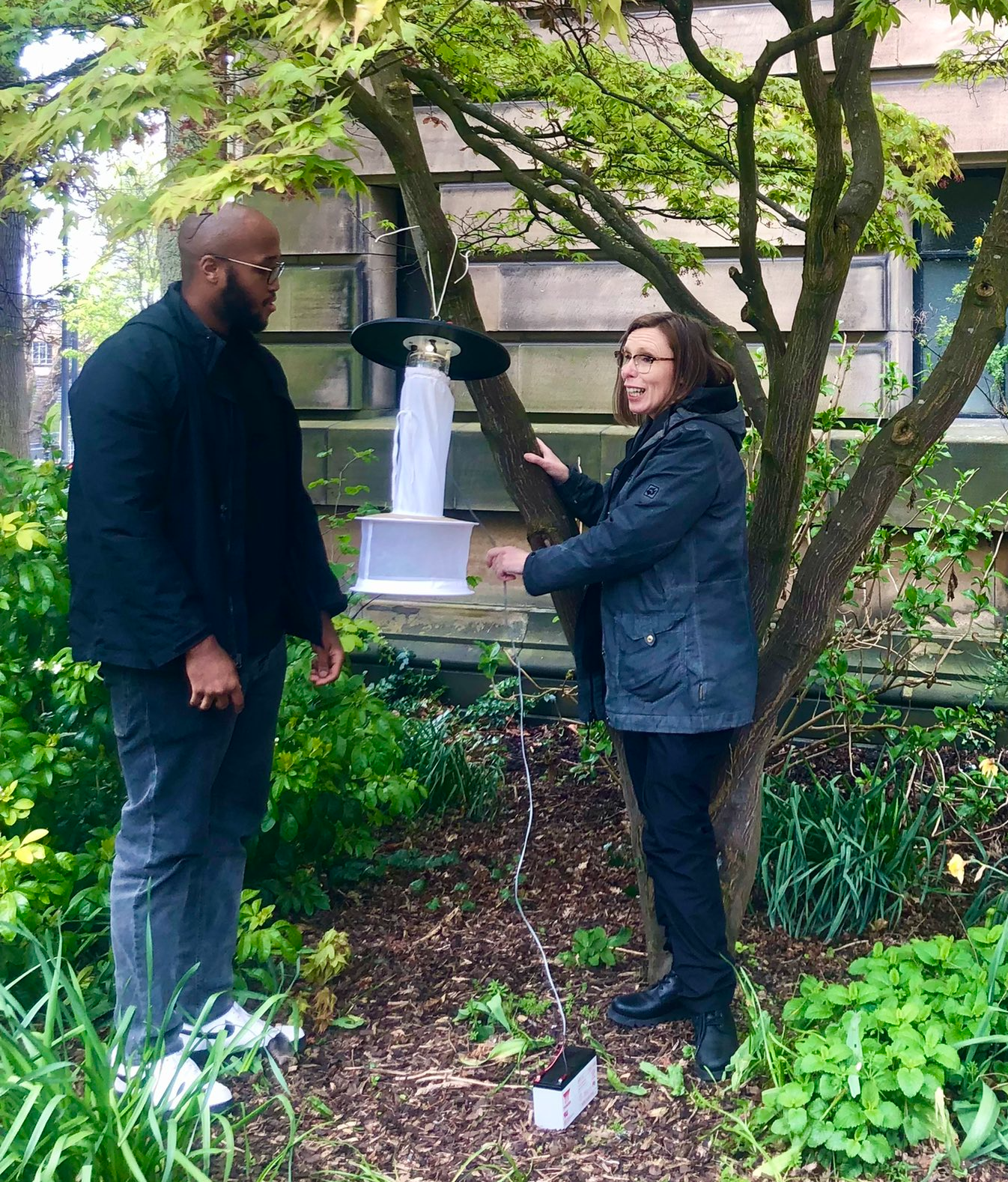 Professor Ferguson and STV News personnel stood with equipment under a tree