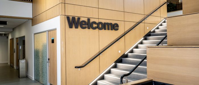 Welcome sign and stairway on the ground floor of the Clarice Pears building