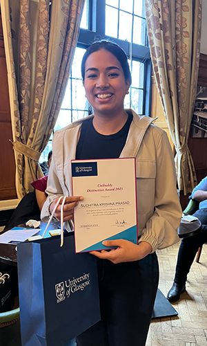 Suchitra proudly holding her award 