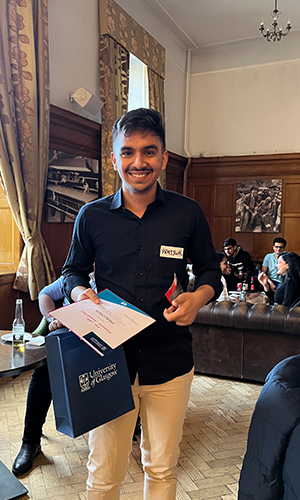 Prajjwal proudly holding his certificate and winnings