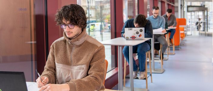 Students studying at tables next to windows in the Clarice Pears Byre's Community Hub
