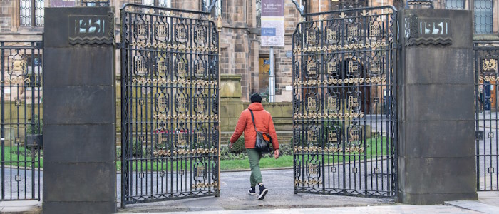 A student walking through the memorial gate