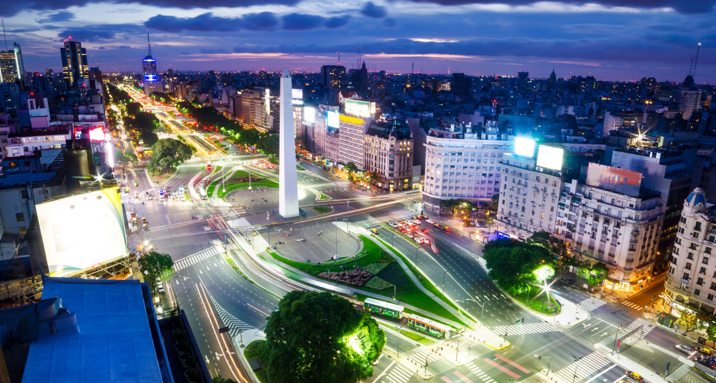 Obelisk in the middle of a busy street at twilight [Photo: Shutterstock]
