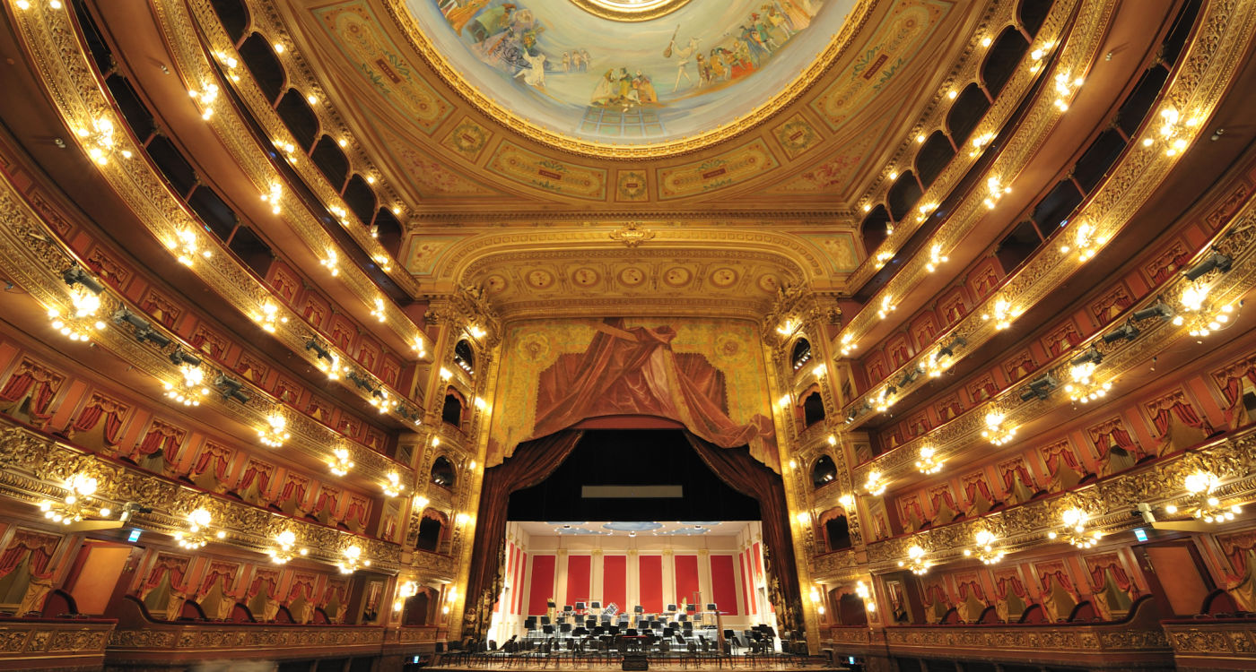 Inside the Theatro Colon (Colon Theater), one of the world's best opera houses - showing the stage, seating and painting on the domed roof [Photo: Shutterstock]
