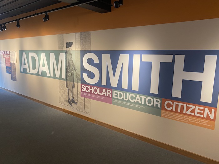 Panel at the entrance to an exhibition with the words 'Adam Smith. Scholar, Educator. Citizen.'