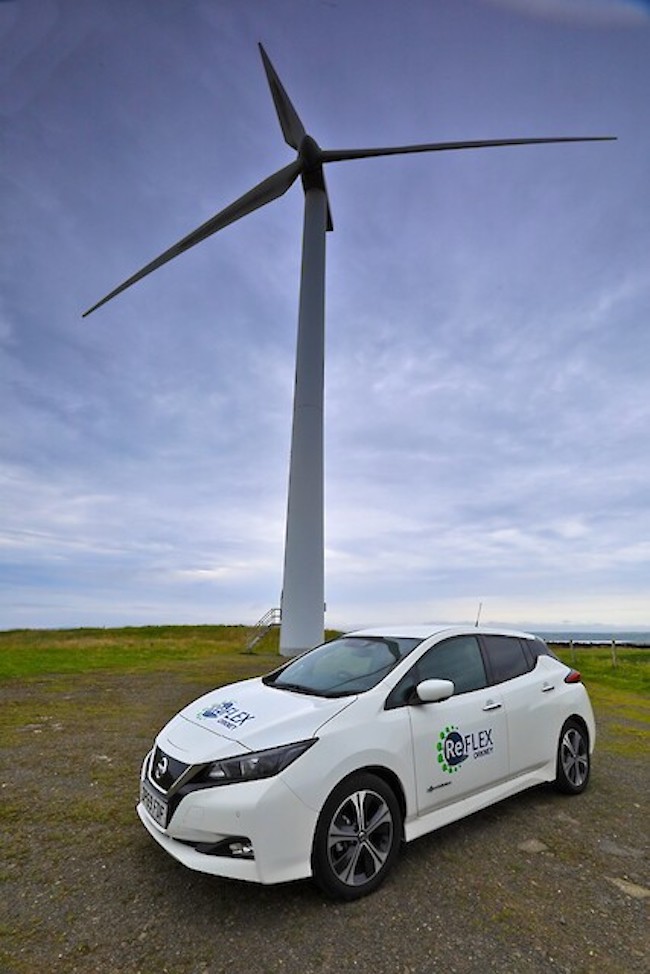 A picture of a ReFLEX-branded car in front of a wind turbine (Photo credit: Colin Keldie)