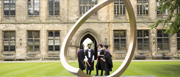 Students at the Alma Mater sculpture in the quadrangle