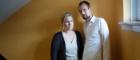 Stacey, a participant in the UofG Cost of Dying study, stands with her partner Joost in the stairwell of their one bedroom flat. 