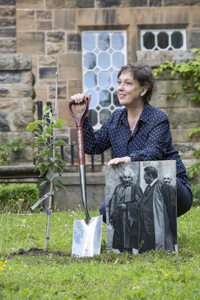 Prof Sheila Rowan poses with a picture of Einstein on the University of Glasgow's campus